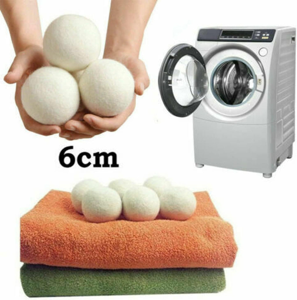 Reusable Wool Dryer Balls held in two hands showing 6cm size