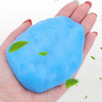 Blue cleaning gel held in a hand with decorative leaves