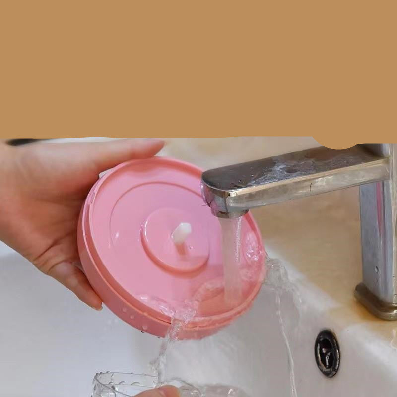 Pull-Cord Manual Chopper lid being rinsed clean under a tap
