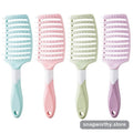 Four pastel detangling brushes with curved flexible bristles in a row | Snagworthy.store