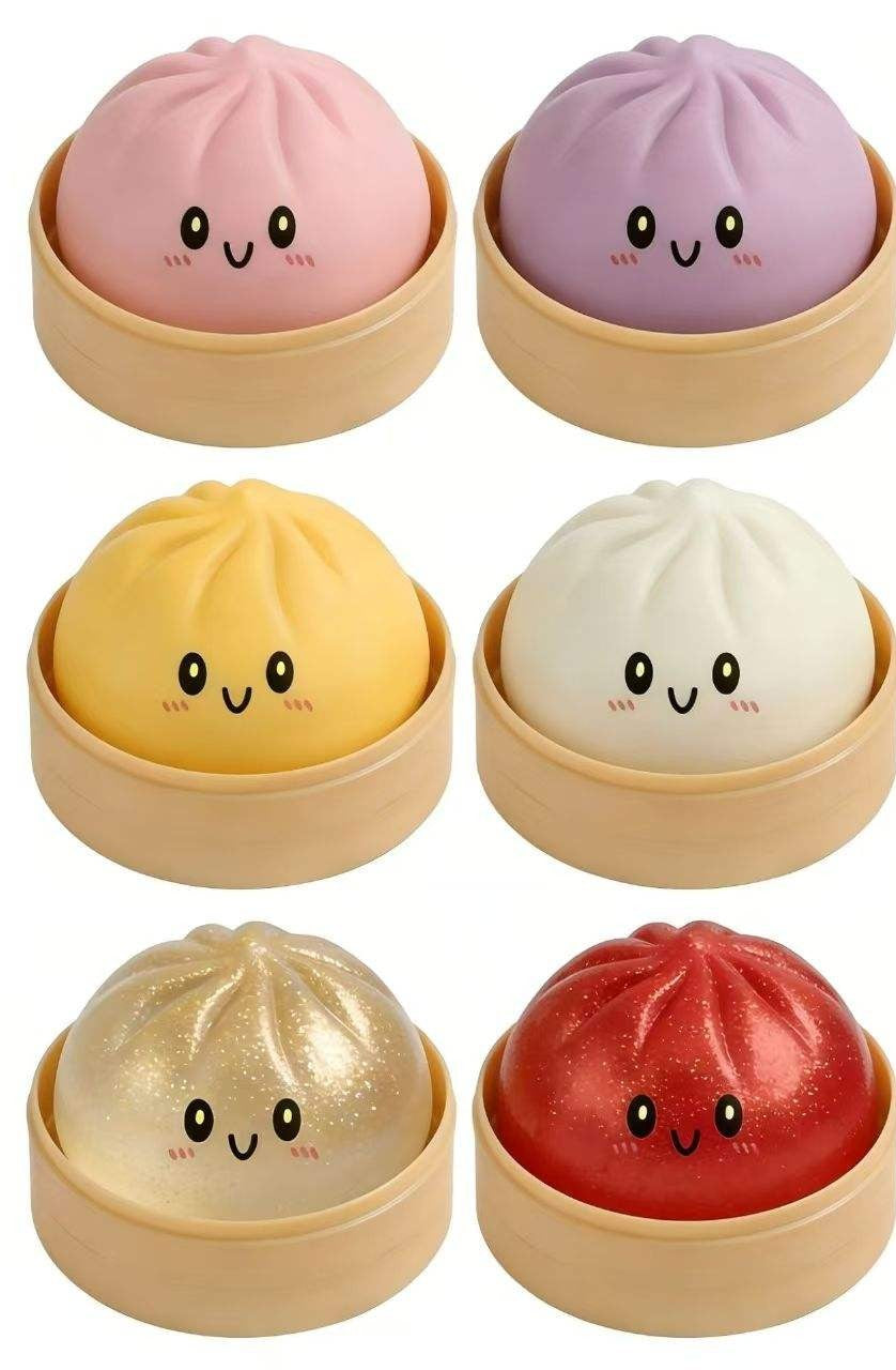 Six smiling dumpling squishy toys in mini steamer baskets, assorted colours