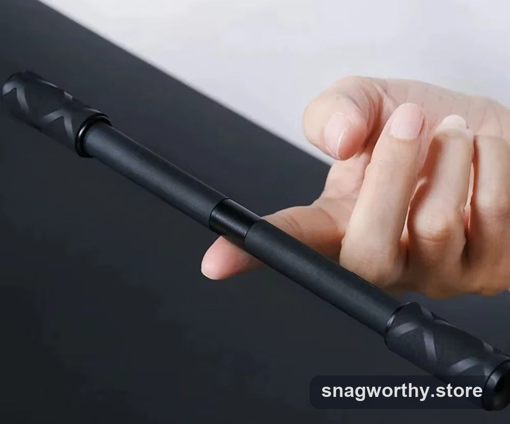 Black metal spinning fidget pen held in a hand | Snagworthy.store