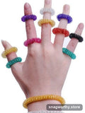 Hand wearing five colourful spring acupressure rings on each finger | Snagworthy.store