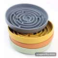 Four stacked silicone slow-feeder maze bowls in grey, yellow, orange and green | Snagworthy.store