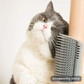 Grey and white cat rubbing its face against a wall-mounted corner self-groomer brush | Snagworthy.store