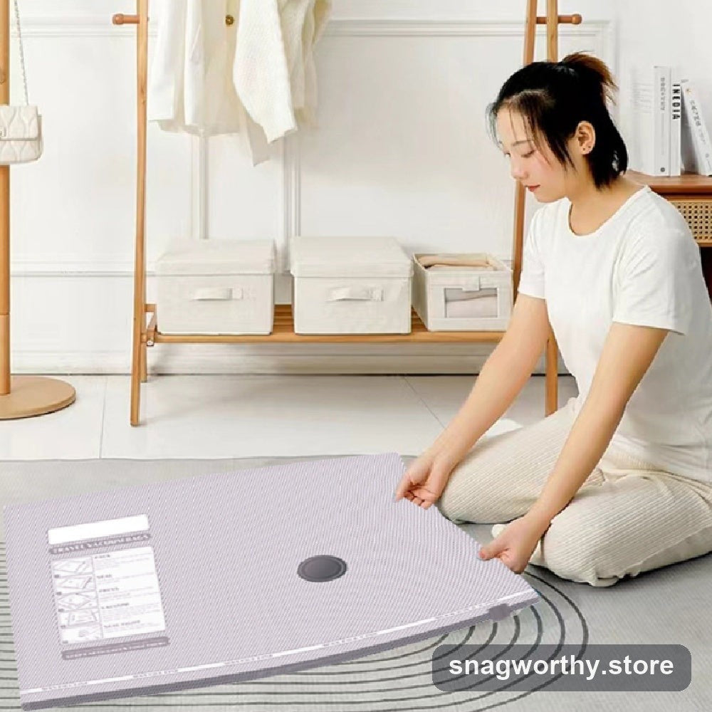 Person rolling air out of a manual vacuum compression storage bag | Snagworthy.store
