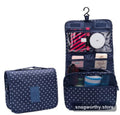 Navy polka-dot hanging toiletry bag folded out with hook | Snagworthy.store