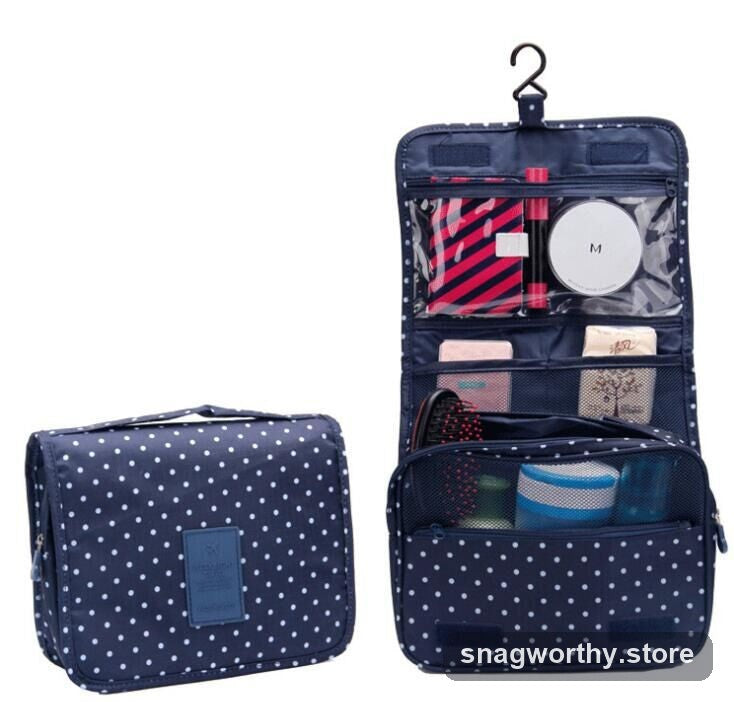 Navy polka-dot hanging toiletry bag folded out with hook | Snagworthy.store