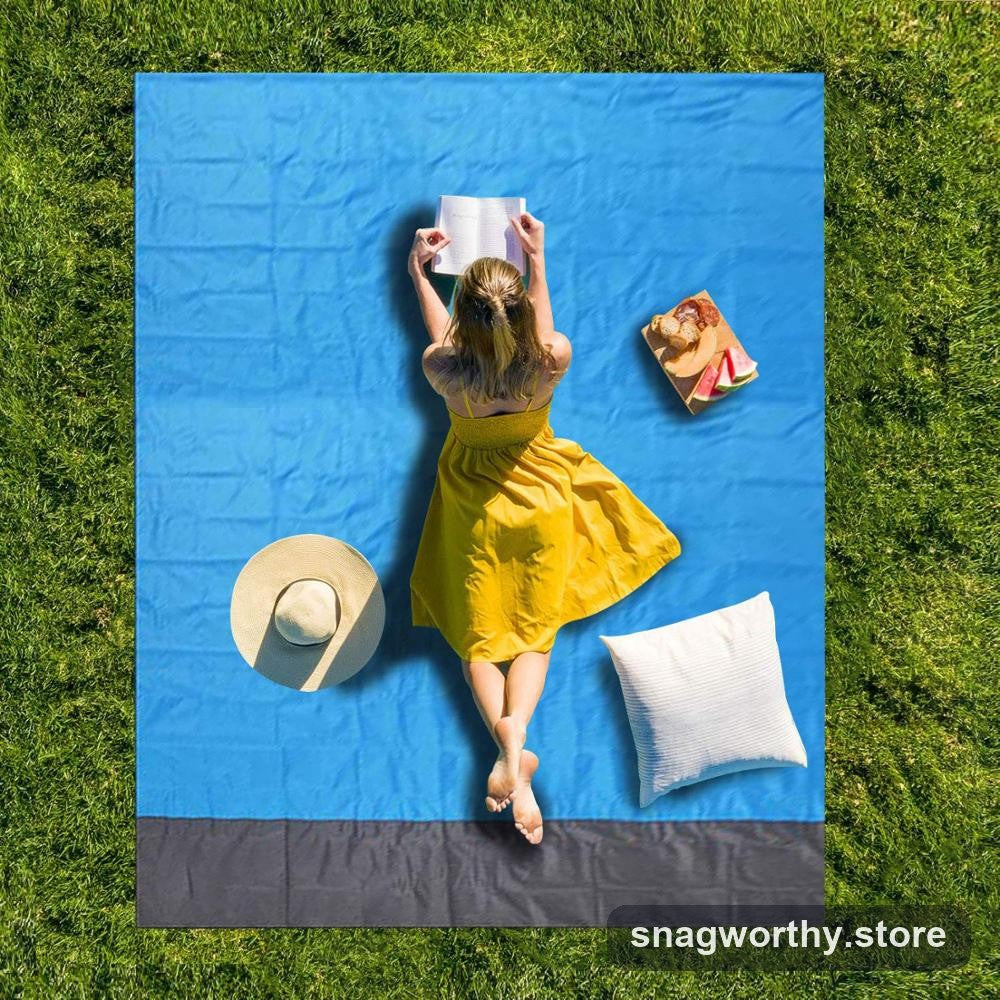 Blue and grey waterproof picnic blanket laid out on grass | Snagworthy.store