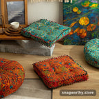 PlushSit tufted floor cushions in orange and teal patterns styled in a living room | Snagworthy.store
