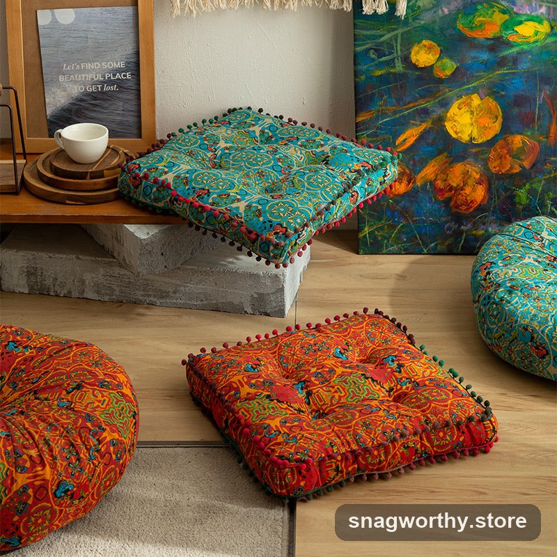 PlushSit tufted floor cushions in orange and teal patterns styled in a living room | Snagworthy.store