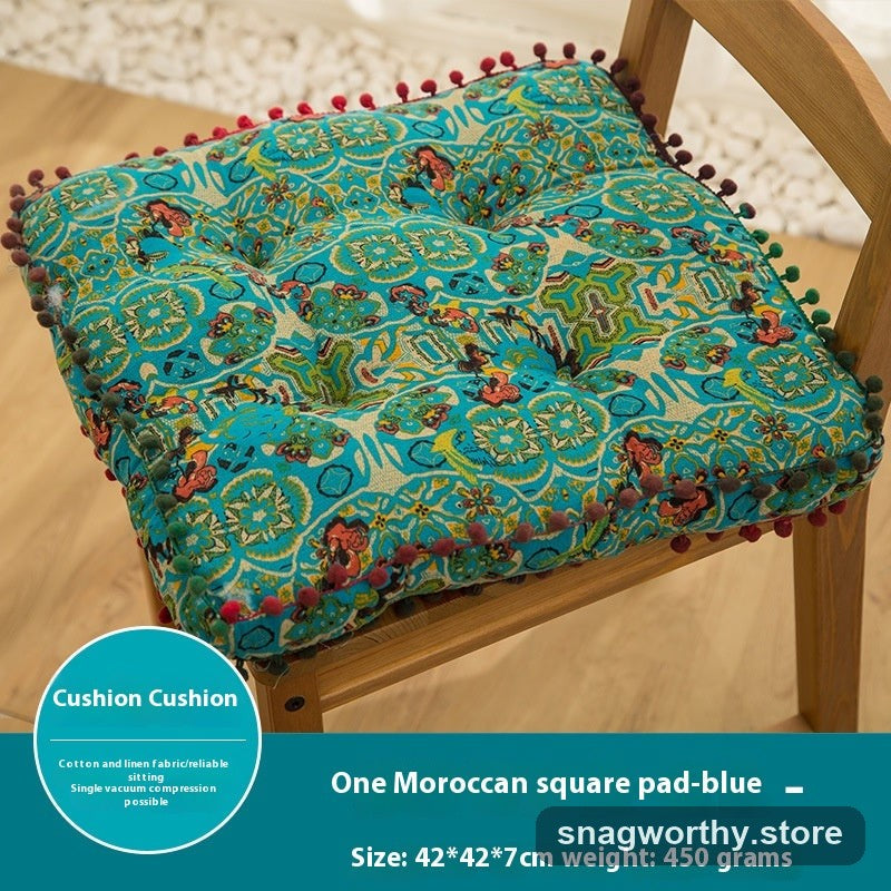 PlushSit tufted floor cushion in blue on a wooden chair, close-up | Snagworthy.store