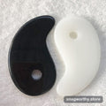 Heart shaped gua sha massage tool in black and white